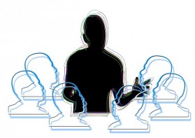 Illustration: eine Lehrkraft ist in der Mitte des Bildes. Um sie herum sind sechs Köpfe angeordnet.